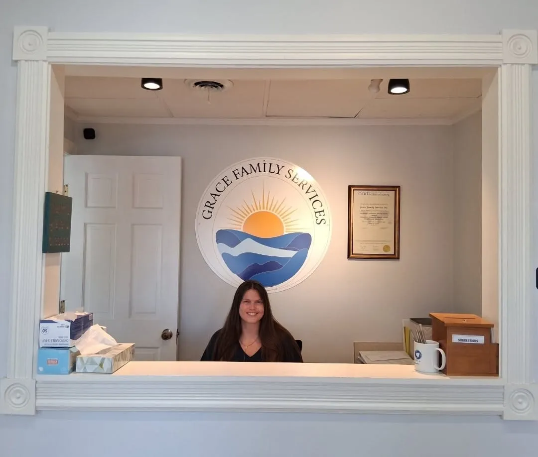 Ashlee, Office Manager, at the Grace Family Services front desk