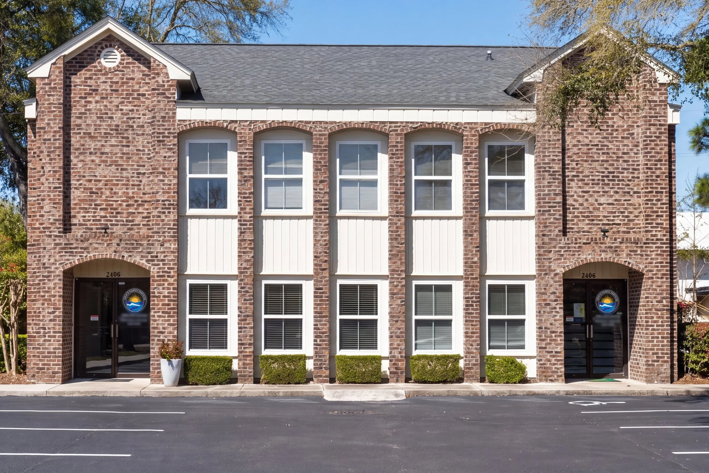 The Grace Family Services building at 2406 Madison Drive in North Myrtle Beach: a two-story brick office with arched windows and two entrances