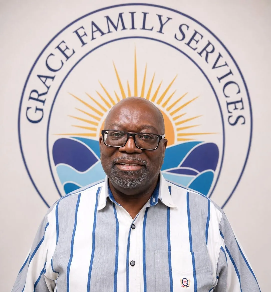 LeRoy, therapist, in front of the Grace Family Services logo mural